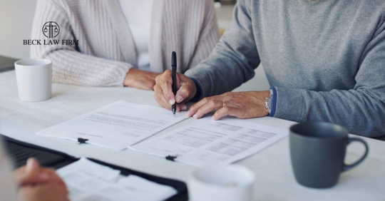 Couple signing estate planning documents